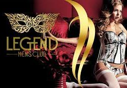 Advertisement for Legend Men's Club featuring a woman in lingerie beside a gold butterfly logo on a dark backdrop.