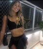 Smiling woman in a black crop top and skirt posing outdoors by a chain-link fence; gold VIP watermark across the image. Smiling woman in a black crop top and skirt posing outdoors by a chain-link fence; gold VIP watermark across the image.