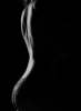 Side silhouette of a person in lace underwear against a black background, with dramatic lighting.